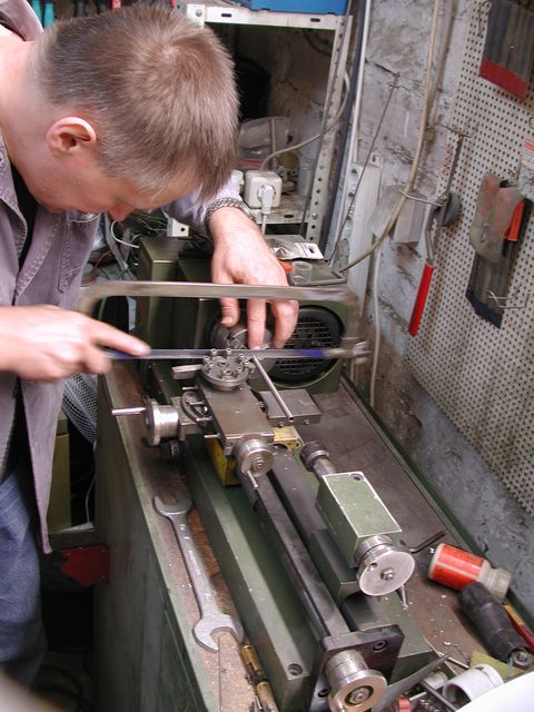 man working with lathe