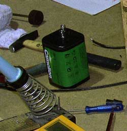Lantern battery and soldering iron on bench